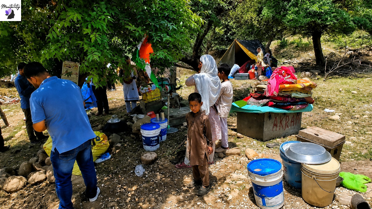 Members of a Gujjar-Bakarwal family sit beneath trees after their homes were demolished